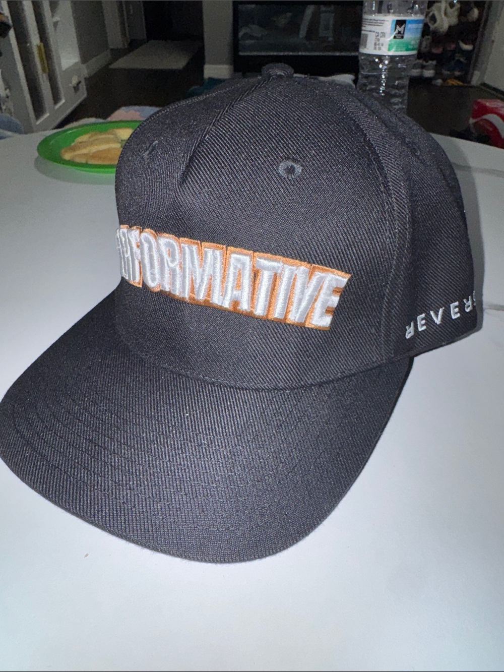 Performative Black Baseball Cap with White and Orange Embroidery